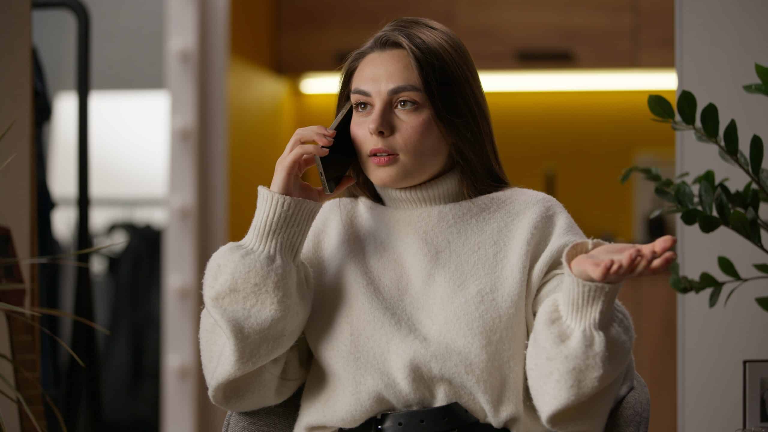 Woman on a phone call gesturing with an open hand