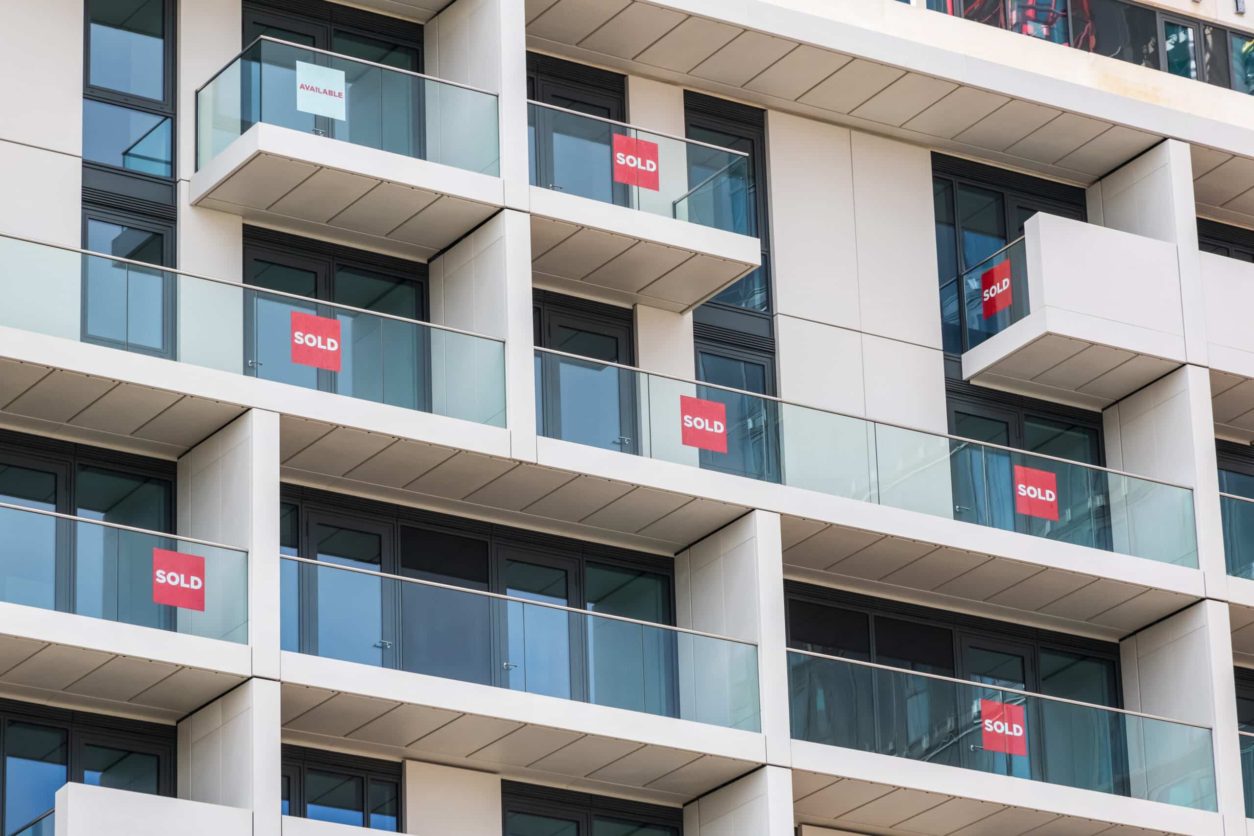 Apartment block balconies with sold signs in the windows