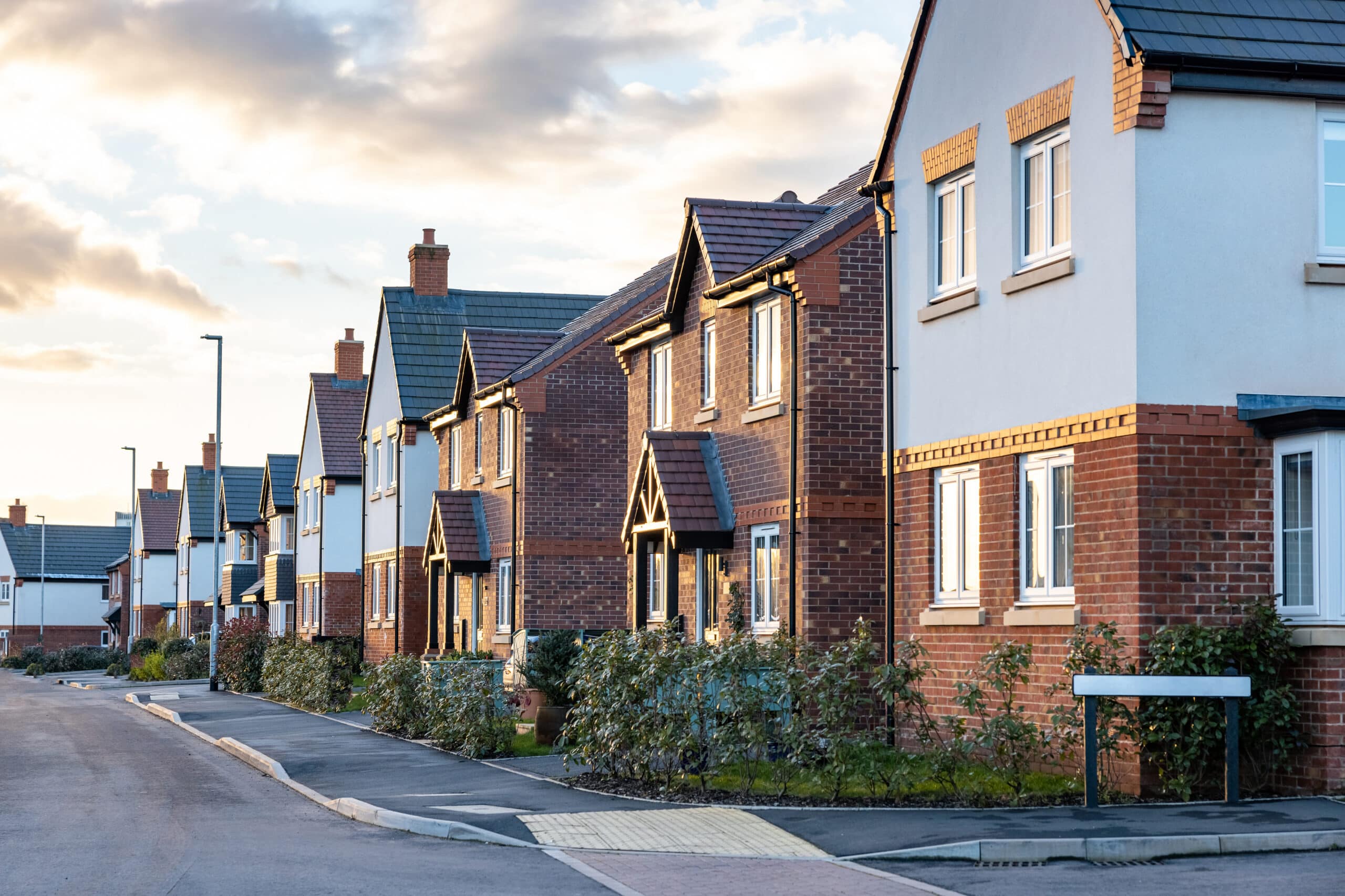 Street of new build brick houses at dusk