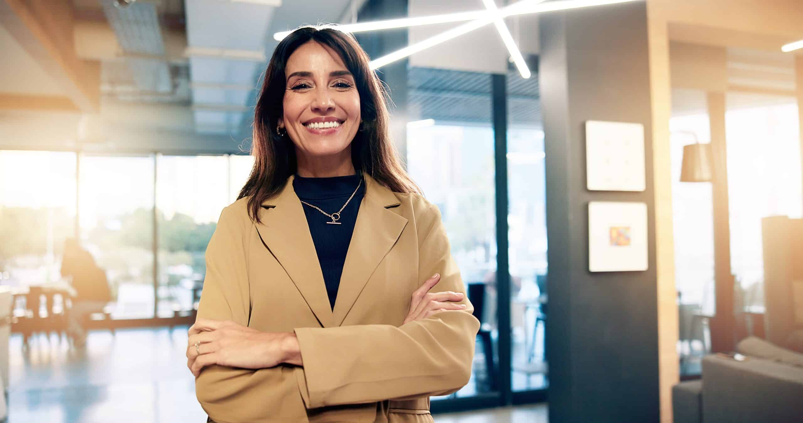 Businesswoman standing with her arms folded in an office