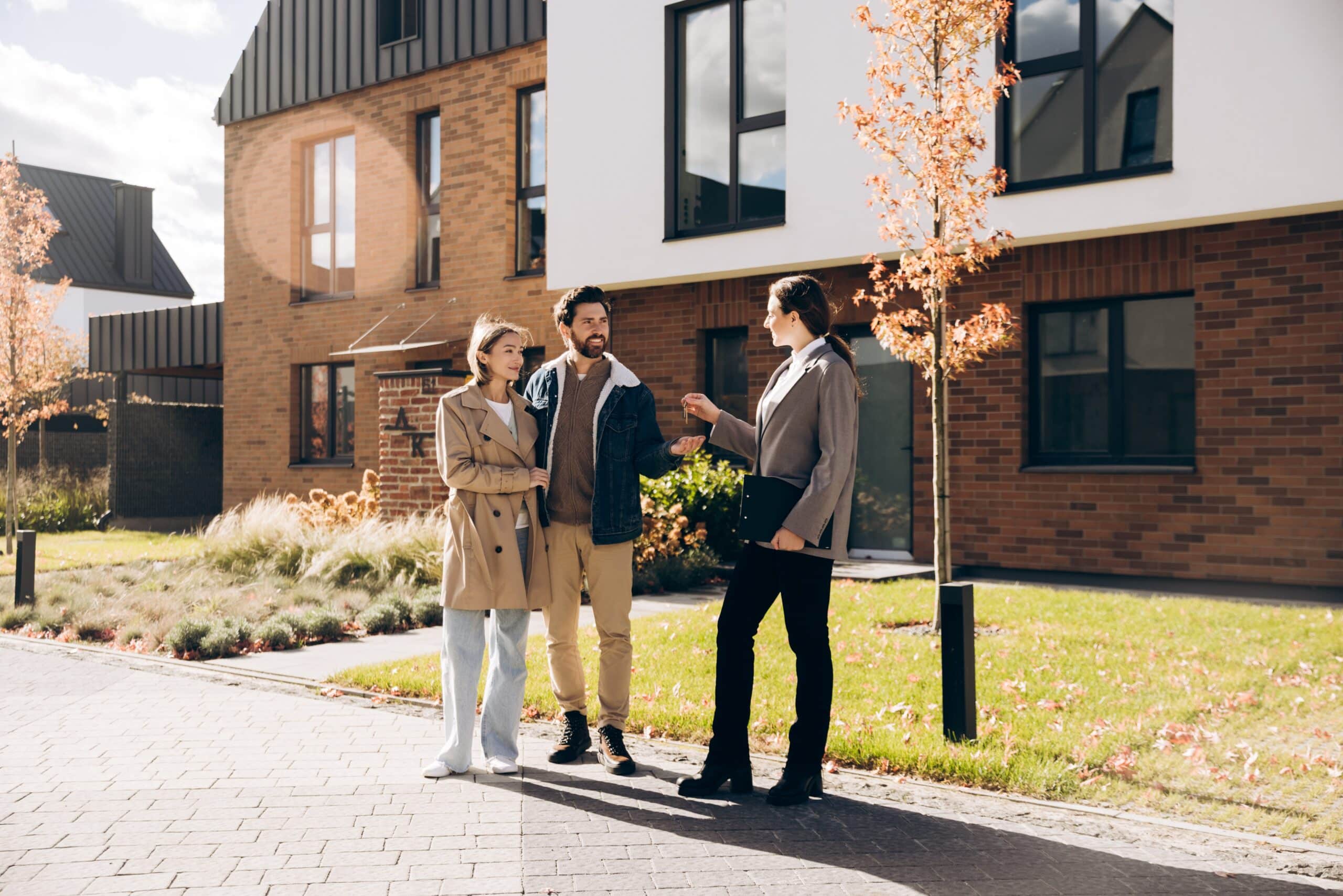 Group viewing a modern apartment block from outside