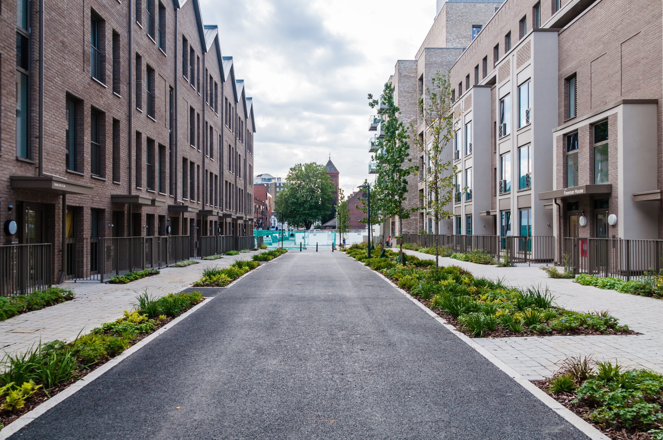 Street of modern brick apartment buildings with a landscaped path