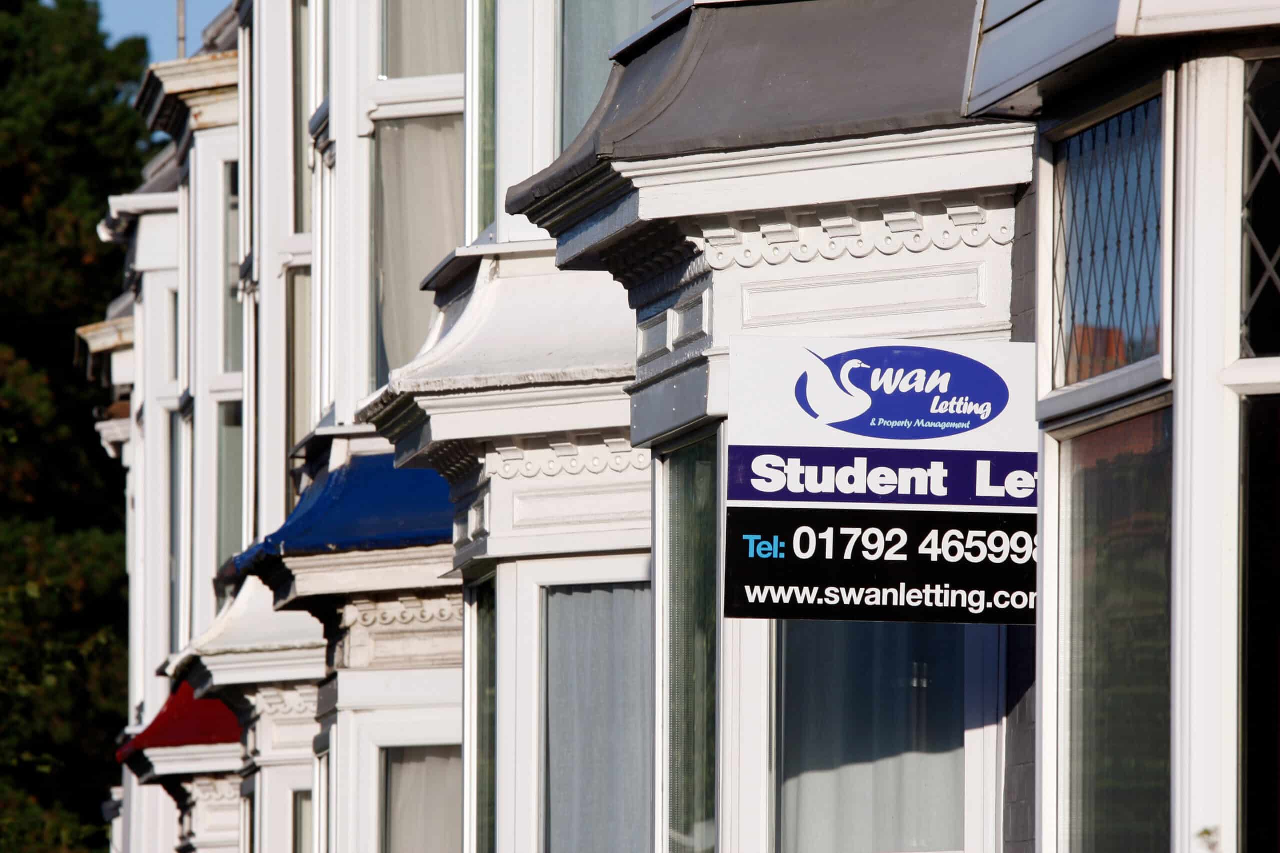 Student letting agency sign fixed to a white Georgian townhouse